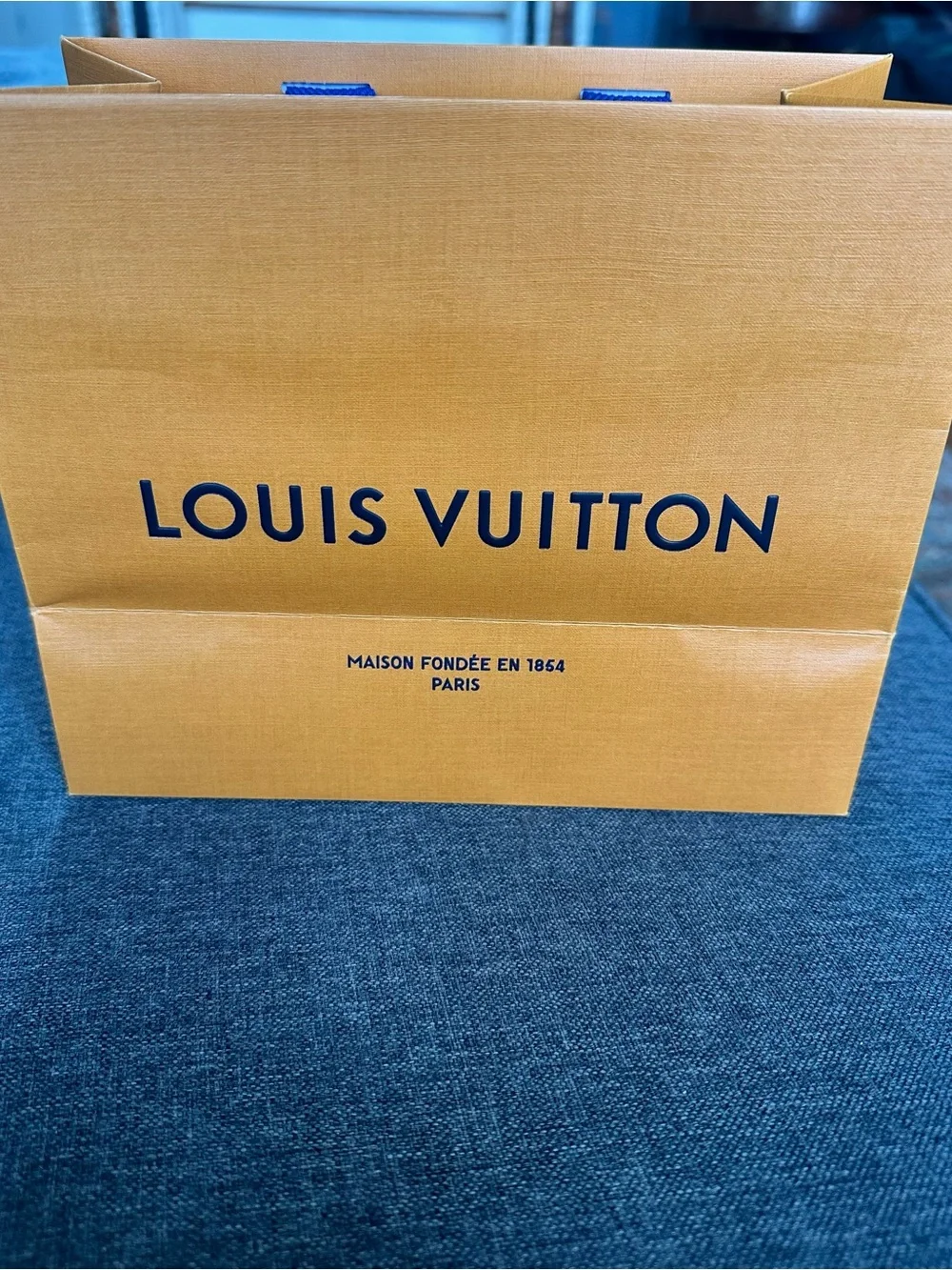 Louis Vuitton Orange Shopping Bag with Blue Handles and Black Logo